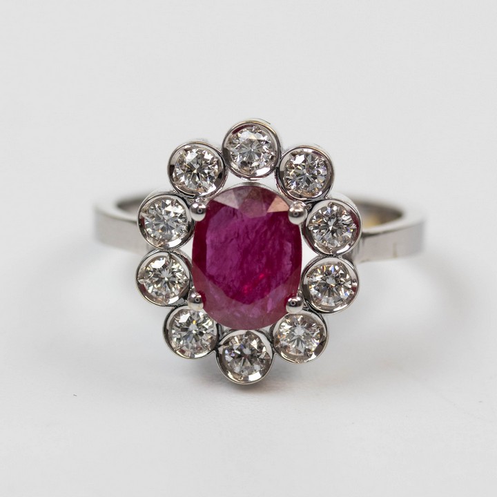 18K White 1.45ct Natural Burmese Pigeons Blood Ruby and 0.70ct Natural Diamond Halo Ring, Size L½, 4.5g. Colour F-G, Clarity VS.  Auction Guide: £2,500-£3,000