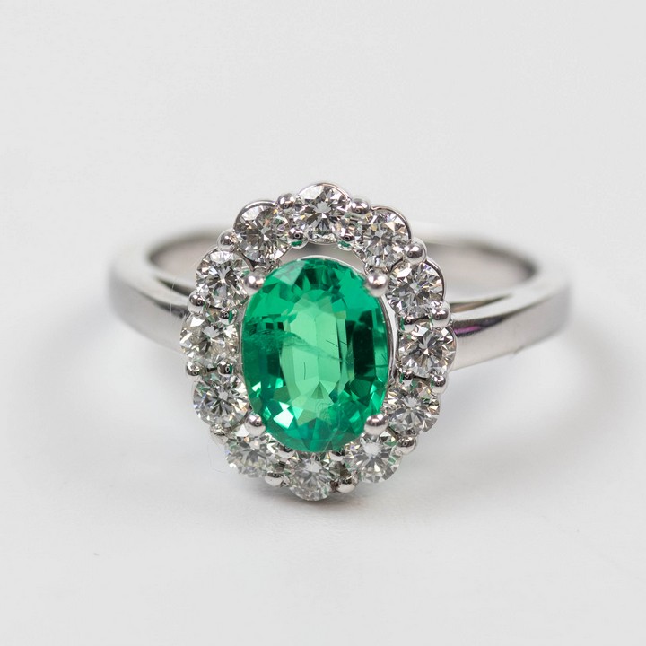 18K White 1.20ct Emerald and 0.80ct Diamond Halo Ring, Size M, 4.5g. Colour F-G, Clarity VVS-VS.  Auction Guide: £2,300-£2,800
