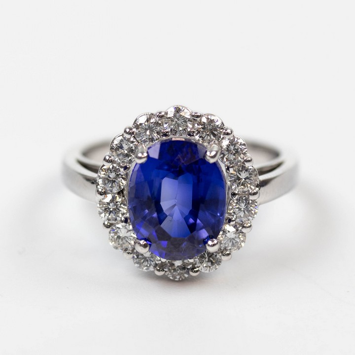 18K White 3.20ct Royal Blue Sapphire and 0.80ct Diamond Halo Ring, Size L½, 5.3g. Colour F-G, Clarity VVS-VS.  Auction Guide: £2,100-£2,600