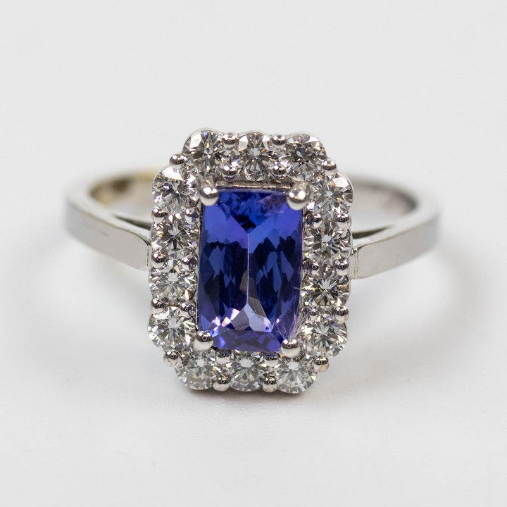 18K White 1.10ct Natural Blue Tanzanite and 0.70ct Diamond Halo Ring, Size M, 3.9g. Colour F-G, Clarity VS.  Auction Guide: £1,100-£1,300