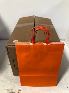 BOX OF PAPER SHOPPING BAGS IN ORANGE: LOCATION - B9