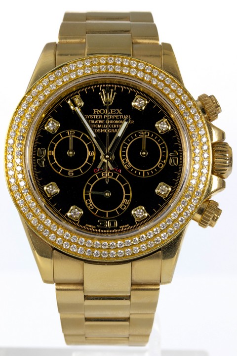 Rolex Daytona Ref: 116528H Automatic Watch. 40mm 18ct Yellow Gold Case with 18ct Yellow Gold After set Diamond Fixed Bezel, Black Dial and 18ct Yellow Gold Oyster Bracelet. Age: 2007/8. Comes with bo