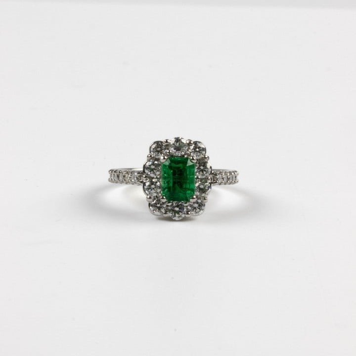 18K White 1.00ct Natural Colombian Emerald and 1.20ct Diamond Halo and Shoulders Ring, Size L½, 4.3g.  Auction Guide: £3,500-£4,000 (VAT Only Payable on Buyers Premium)