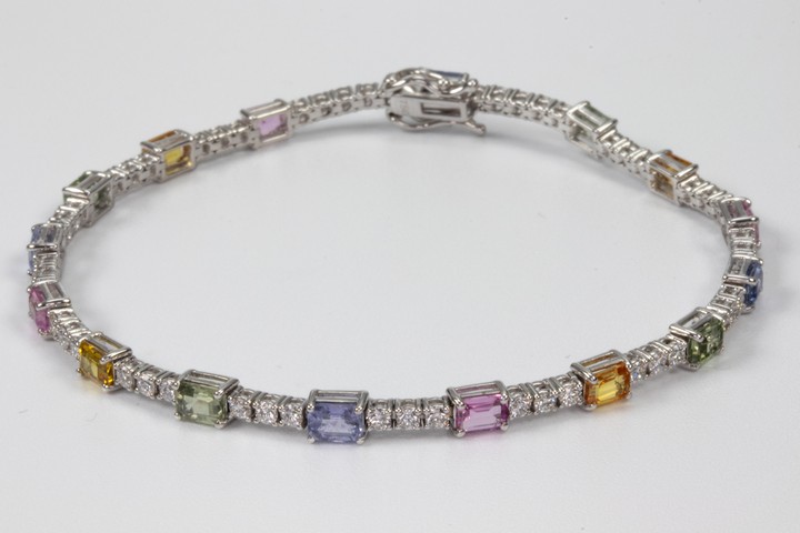 18K White 6.25ct Coloured Sapphires and 1.27ct Diamond Line Bracelet, 18cm, 7.4g.  Auction Guide: £2,000-£2,500