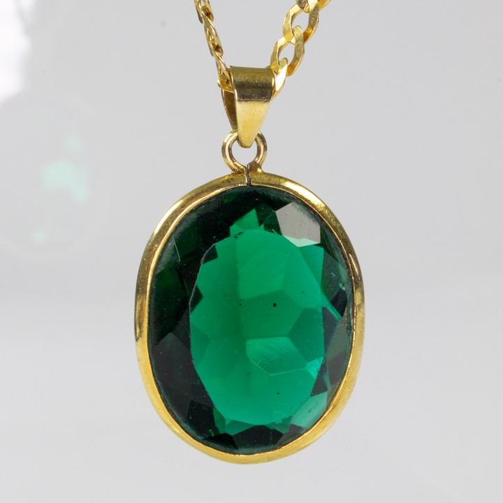 9ct Yellow Gold Green Faceted Oval-cut Pendant, 4x2.5cm and Curb Chain, 46cm, 17.3g.  Auction Guide: £300-£400 (VAT Only Payable on Buyers Premium)