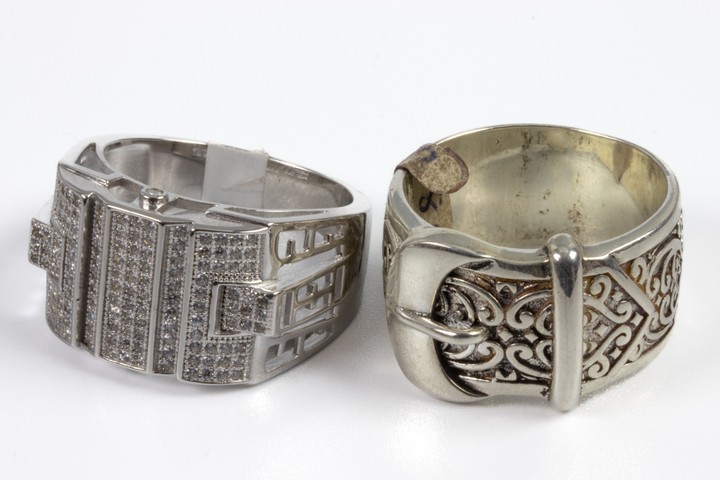Silver Buckle Ring and Silver Clear Stone Pavé Ring, Size X, total weight 27.7g. (VAT Only Payable on Buyers Premium)