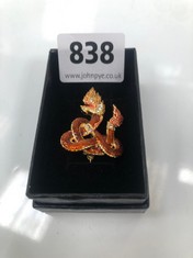 AN ENAMELLED BROOCH OF A SOUTH-EAST ASIAN SNAKE DEITY, BOXED (DELIVERY ONLY)