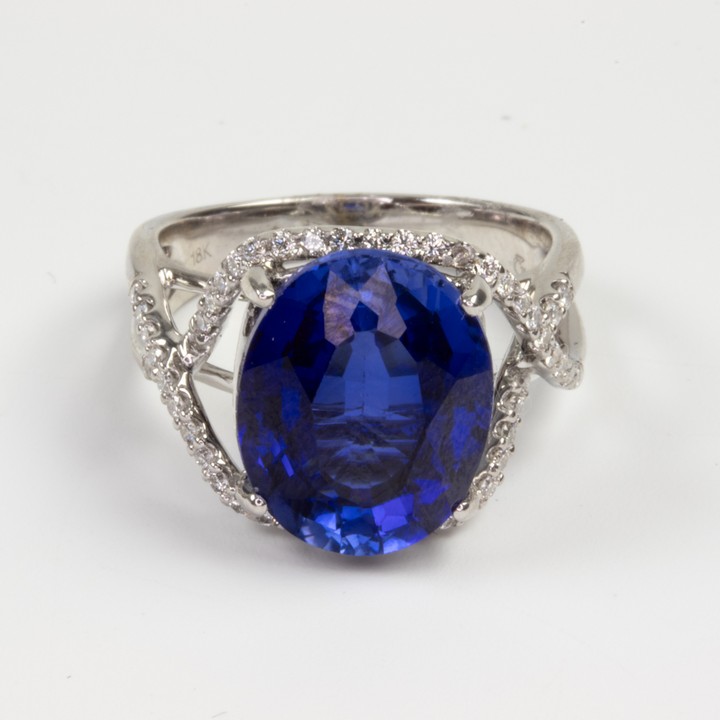 18K White 7.00ct Royal Blue Tanzanite and 0.56ct Diamond Surround and Shoulders Ring, Size O, 7.3g. Colour G, Clarity VS.  Auction Guide: £1,800-£2,300 (VAT Only Payable on Buyers Premium)
