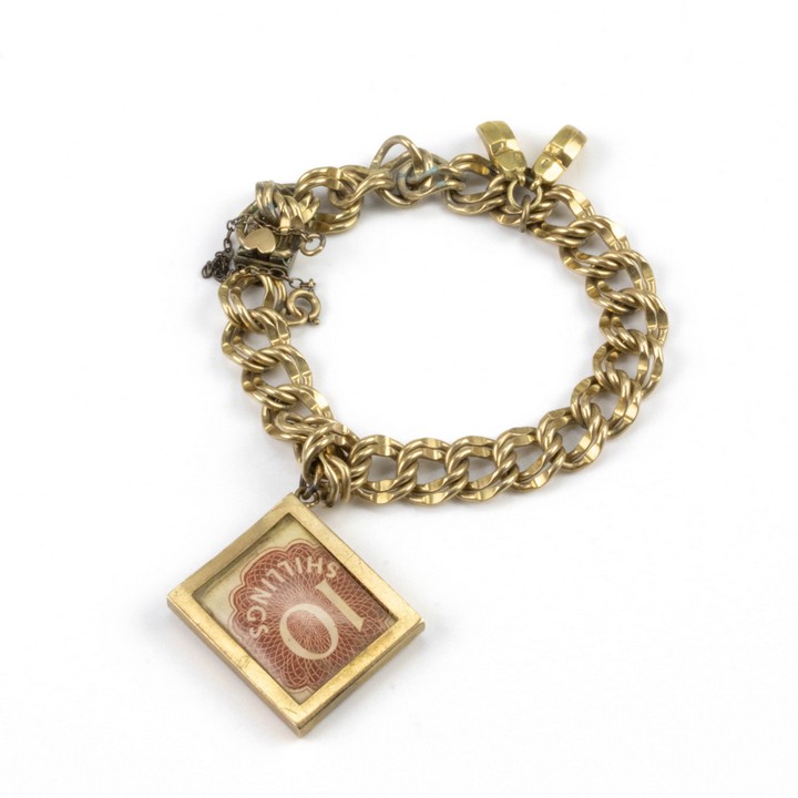 9K Yellow Double Curb Link Safety Chain Bracelet with Gold-Plated Clasp and a 10 Shilling Note and Clogs Charms, 17cm, 22.1g.  Auction Guide: £300-£400 (VAT Only Payable on Buyers Premium)