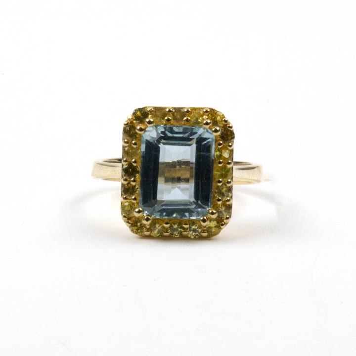 18K Yellow 3.00ct Aquamarine and 1.00ct Yellow Sapphire Halo Ring, Size N½, 4.6g.  Auction Guide: £750-£950 (VAT Only Payable on Buyers Premium)
