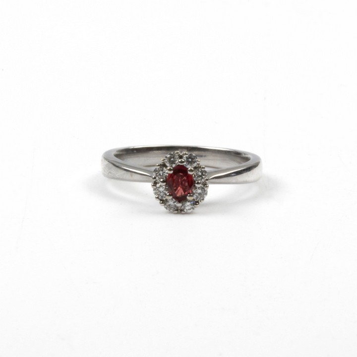 18ct White Gold 0.35ct Ruby and 0.12ct Diamond Halo Ring, Size J½, 3.4g.  Auction Guide: £450-£550