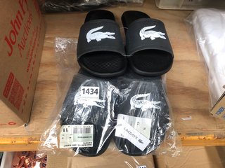 2 X LACOSTE LOGO PRINT SLIDERS IN BLACK SIZE: 9 AND 11: LOCATION - E8