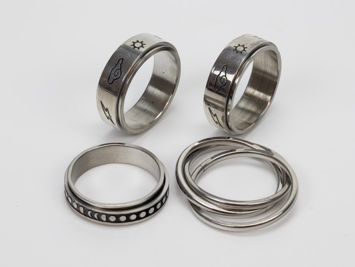 Selection of Four Metal Patterned Band Rings, Size W, total weight 25.8g (VAT Only Payable on Buyers Premium)