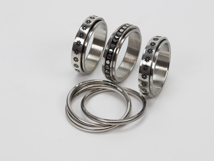 Selection of Four Metal Patterned Band Rings, Size W, total weight 21.9g (VAT Only Payable on Buyers Premium)