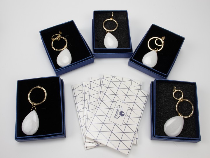 Five Metal White Stone Pendant and Chains, 88cm. All Boxed, total weight 107g. Five Silver Cleaning Cloths (VAT Only Payable on Buyers Premium)