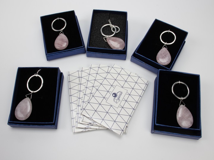 Five Metal Pink Stone Pendant and Chains, 88cm. All Boxed, total weight 104g. Five Silver Cleaning Cloths (VAT Only Payable on Buyers Premium)