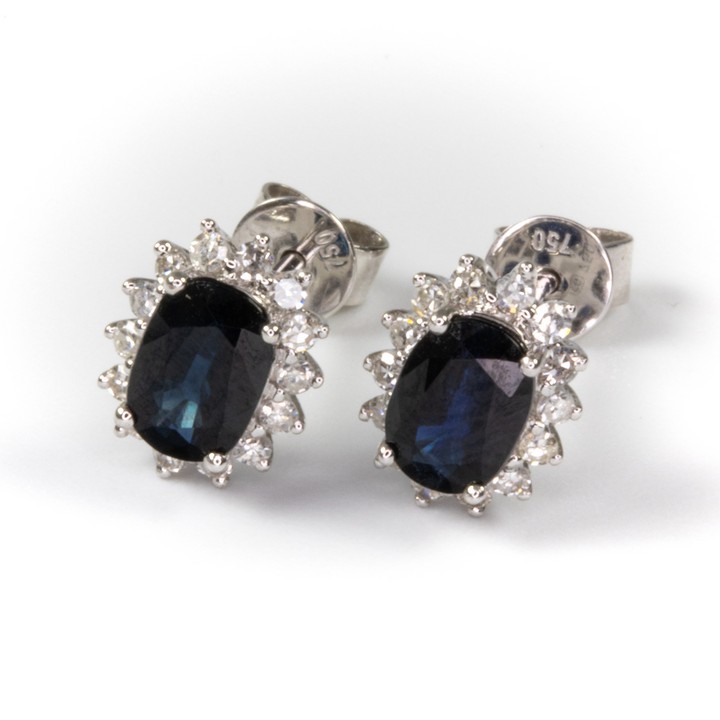 18K White 1.00ct Sapphire and 0.20ct Diamond Halo Stud Earrings, 0.9x0.7cm, 1.8g.  Auction Guide: £500-£700