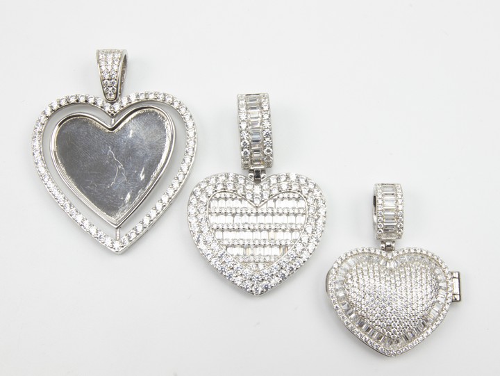 Silver Selection of Three Clear Stone Heart (One Spinning Heart and One Locket) Pendants, 34.9g (VAT Only Payable on Buyers Premium)
