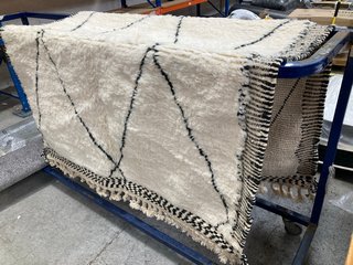 LARGE WHITE/BLACK FLUFFY RUG WITH EDGING: LOCATION - B6