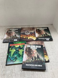 QTY OF ASSORTED BOOKS TO INCLUDE THE WALKING DEAD UNIVERSE ROLEPLAYING CORE RULES BOOK: LOCATION - J11