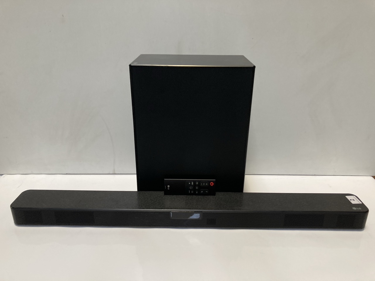 A LG SOUND BAR, BLACK, WITH ADDITIONAL SPEAKER, MODEL SN5 (UNBOXED) RRP £257.00