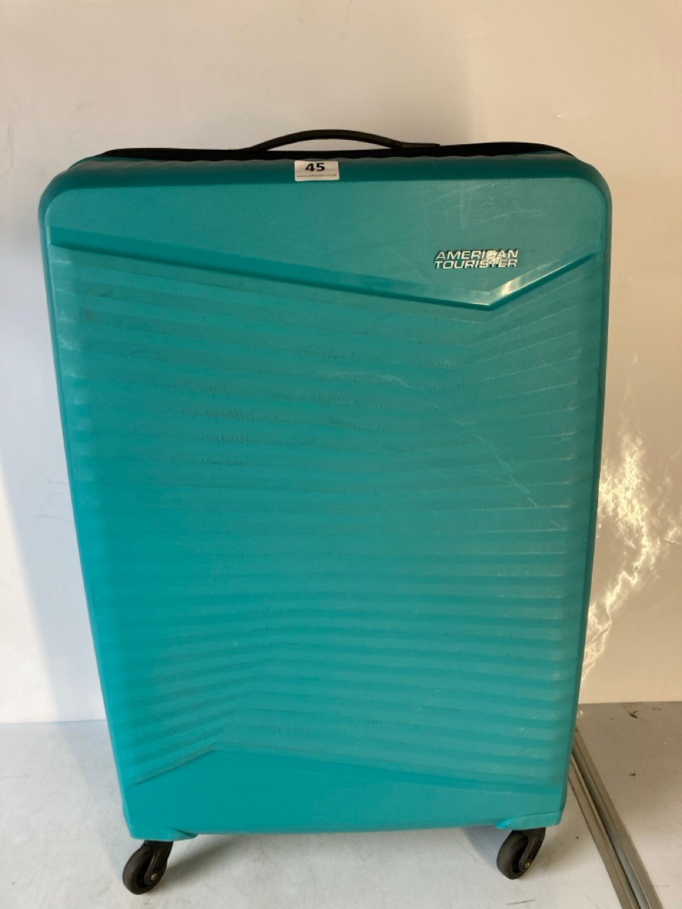 AN AMERICAN TOURISTER SUITCASE