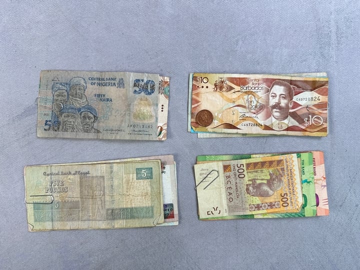 Selection Of Currency, Including Approx 12.1 Barbados Dollars, 310 Egyptian Pounds, 80 South African Rand, 1000 CFA African Francs, Bank Of Mauritius Rupees, Trinidad & Tobago Dollars, Eastern Caribb