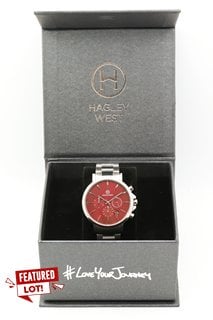 HAGLEY WEST GENTS CHRONOGRAPH WATCH. MODEL HWW14. FEATURING A RED DIAL, DATE, SUBDIALS, W/R 5ATM, STAINLESS STEEL CASE AND BRACELET.: LOCATION - FRONT BOOTH