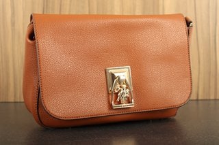 US POLO ASSN LEATHER BUCKLE SHOULDER BAG IN BROWN WITH POLISHED GOLD DETAIL: LOCATION - FRONT BOOTH