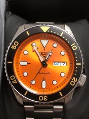 QUANTITY OF ITEMS TO INCLUDE A SEIKO WATCH STAINLESS STEEL STRAP ORANGE FACE : LOCATION - F