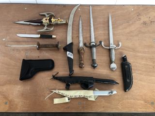 *18+ ONLY* QTY OF ASSORTED REPLICA METAL DAGGERS TO INCLUDE MULTI TOOL WITH AXE AND REPLICA METAL DAGGER WITH CROSS GUARD IN SILVER COLOUR