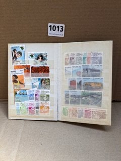 A STOCK BOOK OF ASSORTED VINTAGE STAMPS: LOCATION - AR8