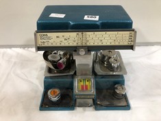 A 1970S COIN MEASURING MACHINE WITH WEIGHTS