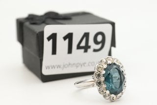 A SILVER COLOUR METAL RING SET WITH CLEAR AND BLUE STONES: LOCATION - CR