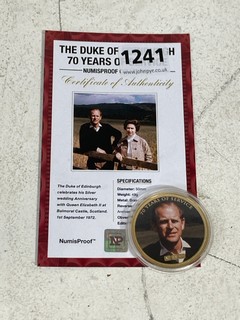 A 24 CARAT GOLD PLATED BRASS COMMEMORATIVE COIN, HRH THE DUKE OF EDINBURGH, 70 YEARS OF SERVICE, WITH EDITION CERTIFICATE: LOCATION - BR1