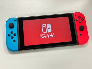 NINTENDO SWITCH OLED MODEL 64GB GAMES CONSOLE (ORIGINAL RRP - £309) IN NEON BLUE / NEON RED: MODEL NO HEG-001 (BOXED WITH ALL ACCESSORIES) [JPTM121748]. THIS PRODUCT IS FULLY FUNCTIONAL AND IS PART O