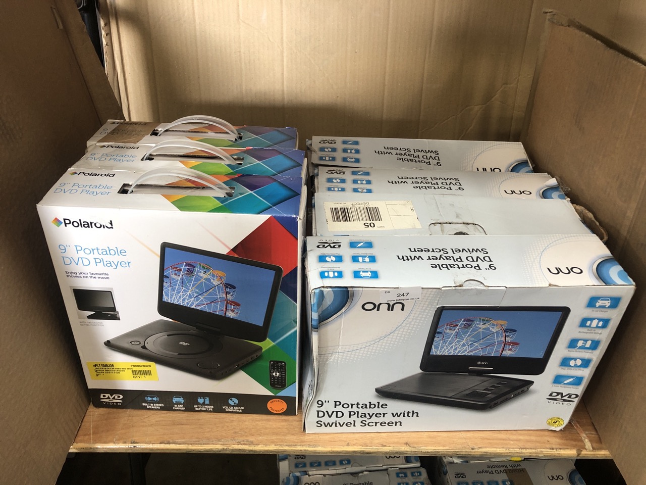 QUANTITY OF ASSORTED DVD PLAYERS TO INCLUDE POLAROID 9" PORTABLE DVD PLAYER: LOCATION - RIGHT REAR TABLES(COLLECTION OR OPTIONAL DELIVERY AVAILABLE)