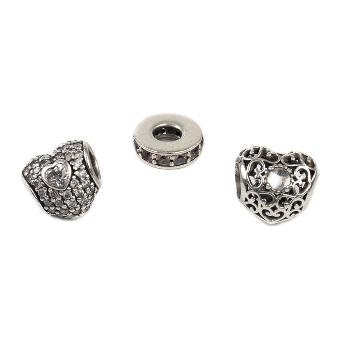 Pandora Silver Three Charms including Filigree Heart with Clear Stone, Purple Stone Channel Spacer, Clear Stone Pavé Heart, total weight 5g (VAT Only Payable on Buyers Premium)