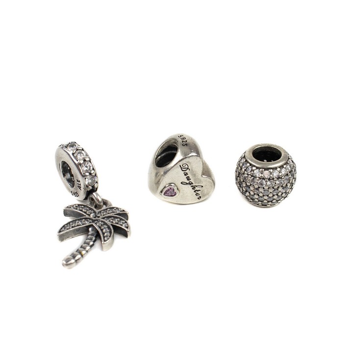 Pandora Silver Three Charms including Purple Stone Daughter, Heart, Clear Stones Pine Tree Drop, Clear Stone Pavé Ball, total weight 8.4g (VAT Only Payable on Buyers Premium)