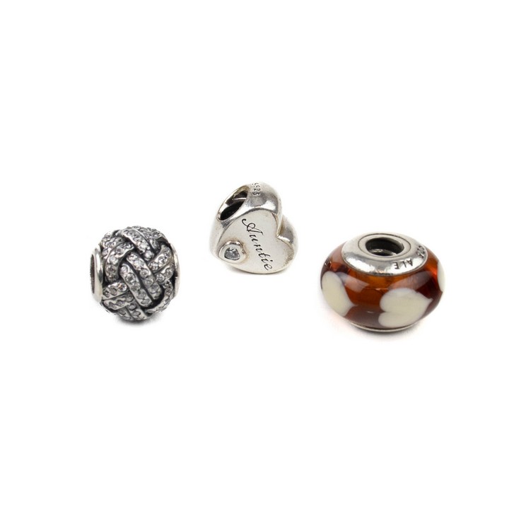 Pandora Silver Three Charms including Clear Stone Heart Auntie, Clear Stone Pavé Ball, Orange and White Hearts Glass Bead, total weight 9.7g (VAT Only Payable on Buyers Premium)