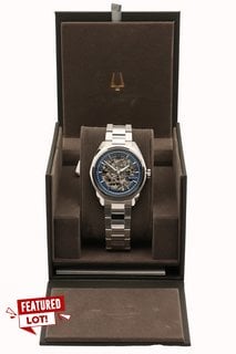 BULOVA SURVEYOR MEN'S AUTOMATIC WATCH. FEATURING A BLUE SKELETON DIAL, SILVER COLOURED BEZEL AND EXHIBITION CASE, W/R 10ATM, STAINLESS STEEL BRACELET. COMES IN A PRESENTATION BOX - RRP £399: LOCATION