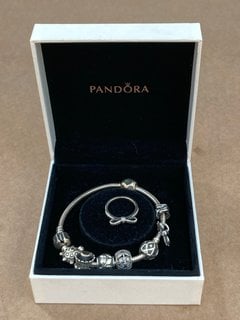 PANDORA STAINLESS STEEL 7 CHARM BRACELET TO INCLUDE SILVER BOW SHAPED RING: LOCATION - F11