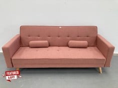 TWO SEATER SOFA BED CORAL PINK WITH CUSHIONS AND WOODEN LEGS.