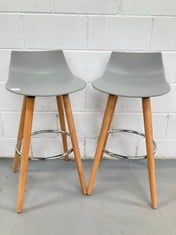 2 X GREY BAR STOOLS WITH WOODEN LEGS AND CHROME FOOTRESTS .