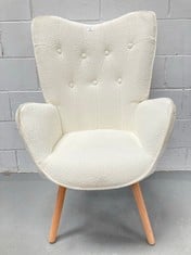 CREAM COLOURED ARMCHAIR WITH SHEEPSKIN AND WOODEN LEGS (THIS ONE HAS BEEN SCUFFED).