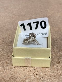 A SILVER COLOURED STONE SET RING: LOCATION - CR