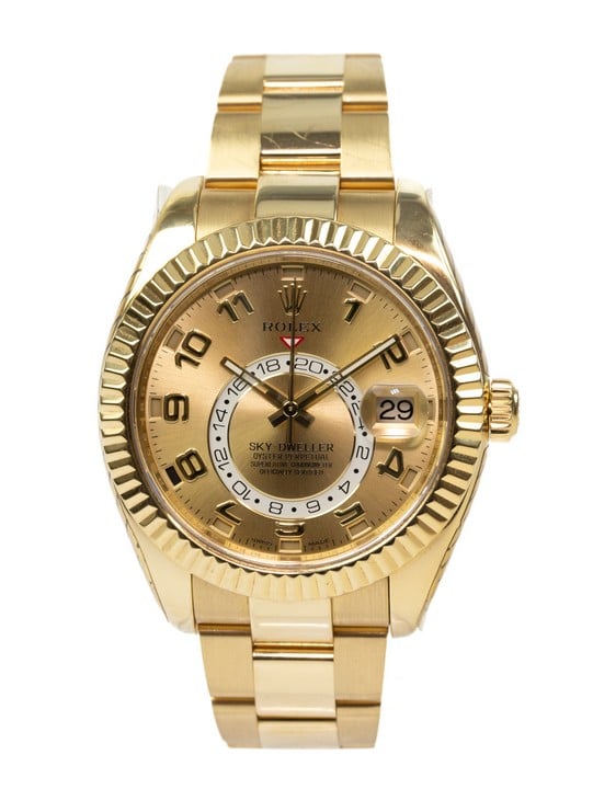 Rolex Sky-Dweller Automatic Watch
Ref: 326938
Year: 2010
Size: 42mm
Movement: Automatic
Case: 18ct Yellow Gold Case with 18ct Yellow Gold Fluted Ring Command Bezel, Champagne Dial with Arabic Numeral