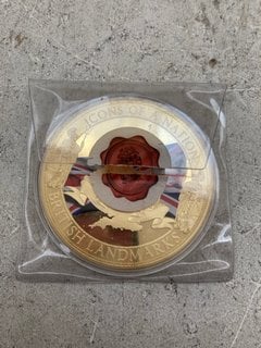 A 22 CARAT GOLD PLATED VERY LARGE OVERSIZED COMMEMORATIVE COIN "ICONS OF A NATION" THE PALACE OF WESTMINSTER, WITH A SWAROVSKI INSERT AND CERTIFICATE OF AUTHENTICITY, SEALED: LOCATION - AR19