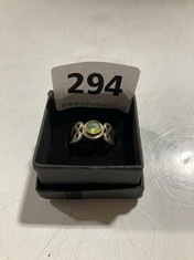 SILVER COLOURED RING WITH GREEN STONE SET IN CELTIC STYLE BASE