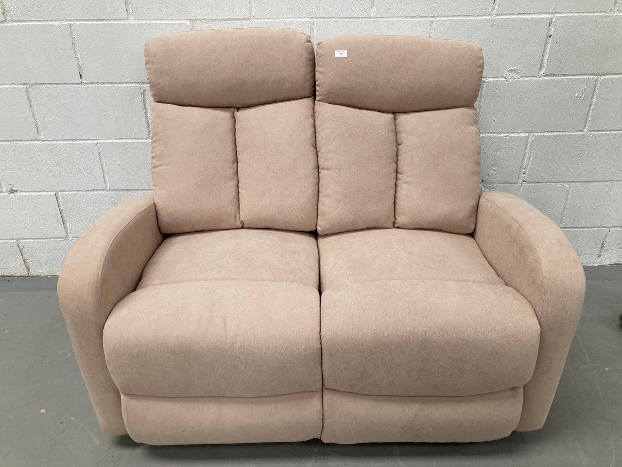 LIGHT PINK RECLINING TWO SEATER SOFA.